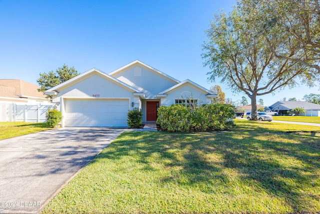 view of front of home with a front yard and a garage