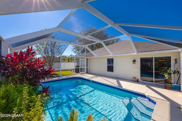 view of pool with a lanai and a patio