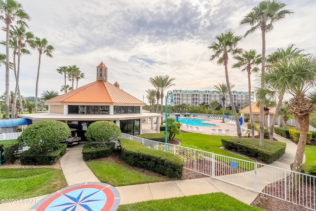 view of community with a lawn and a pool