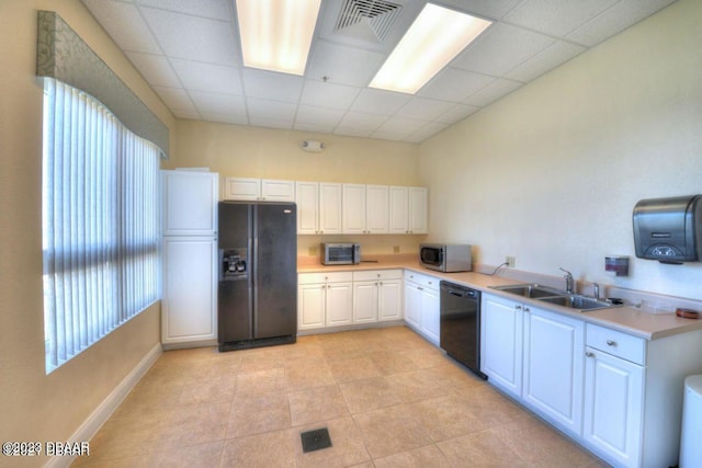 kitchen with white cabinets, plenty of natural light, black appliances, and sink