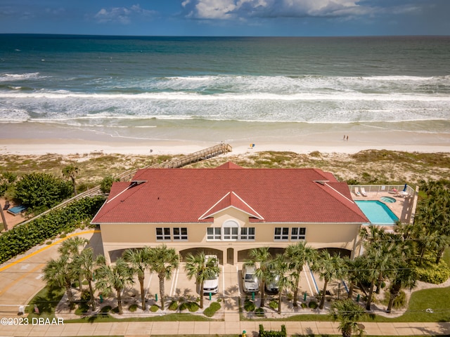 bird's eye view with a water view and a beach view