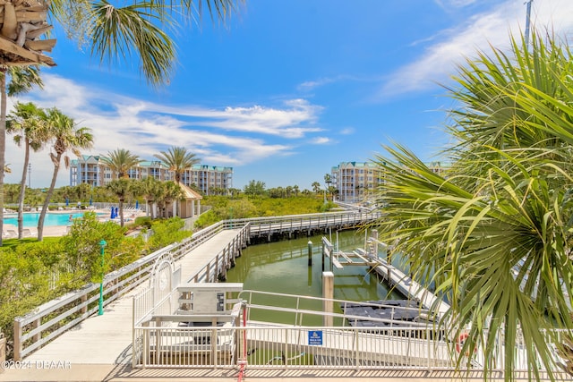 dock area with a water view and a community pool