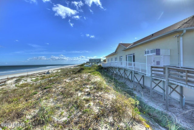 view of yard featuring a view of the beach and a water view