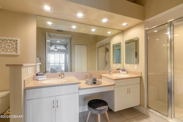 bathroom with ceiling fan, vanity, tile patterned flooring, and a shower with door