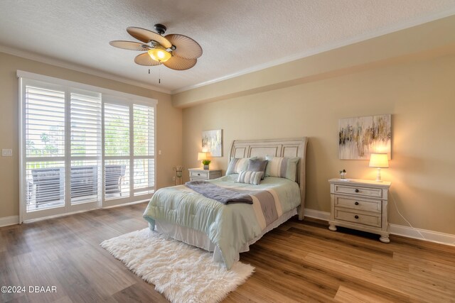 bedroom with ornamental molding, ceiling fan, a textured ceiling, and light hardwood / wood-style floors