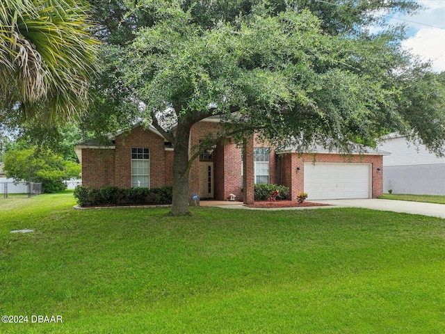 view of front of property with a garage and a front yard