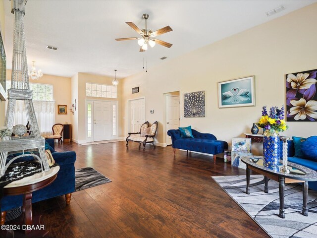 living room featuring hardwood / wood-style flooring and ceiling fan with notable chandelier