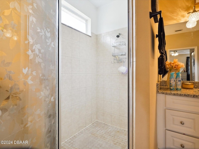 bathroom with vanity, ceiling fan, and a shower with shower door