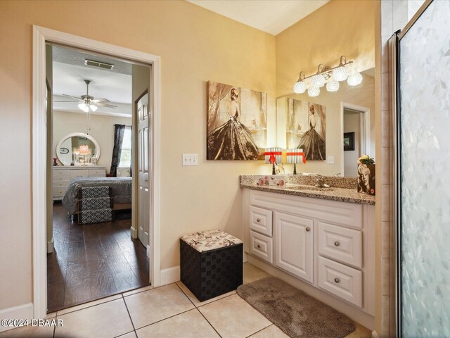 bathroom featuring hardwood / wood-style flooring, ceiling fan, vanity, and a shower with shower door