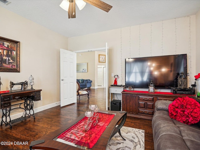 living room with ceiling fan, a textured ceiling, and dark hardwood / wood-style flooring