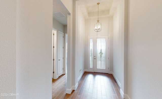 entrance foyer featuring light hardwood / wood-style flooring and an inviting chandelier