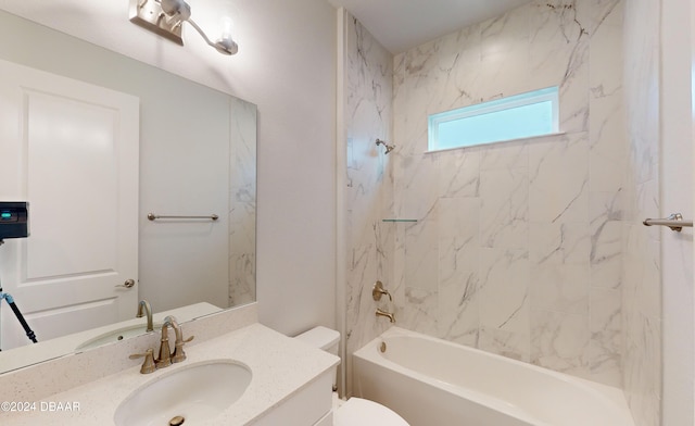 full bathroom featuring vanity, tiled shower / bath combo, and toilet