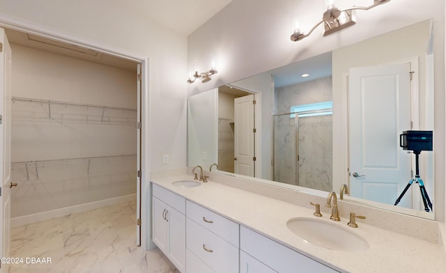 bathroom with vanity and a shower with door