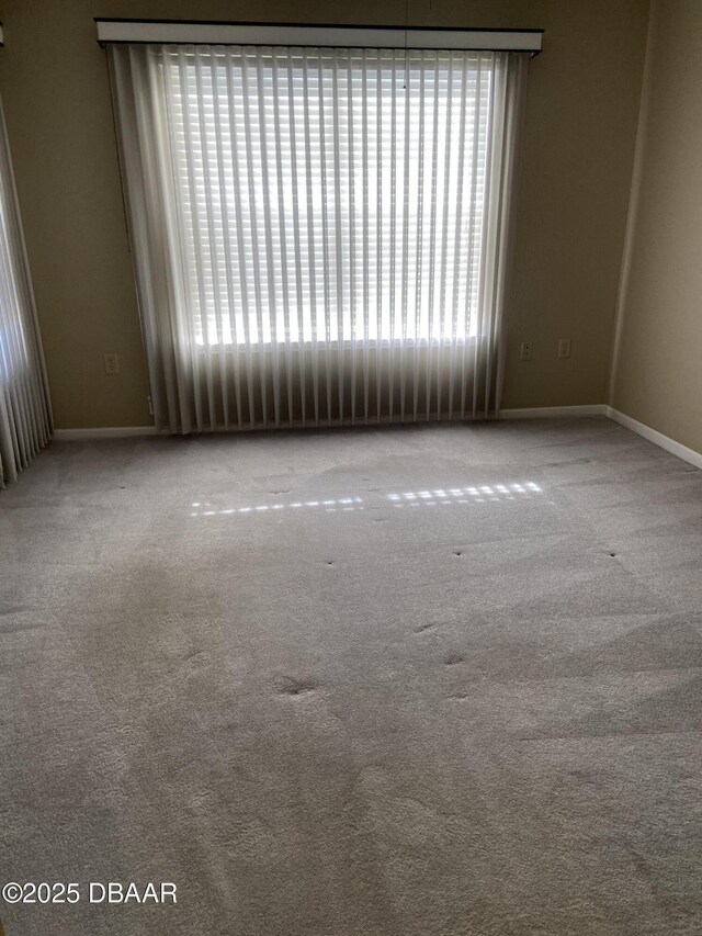 940 Village Trl Unit 2-106, Port Orange, FL 32127 - spare room with baseboards and carpet