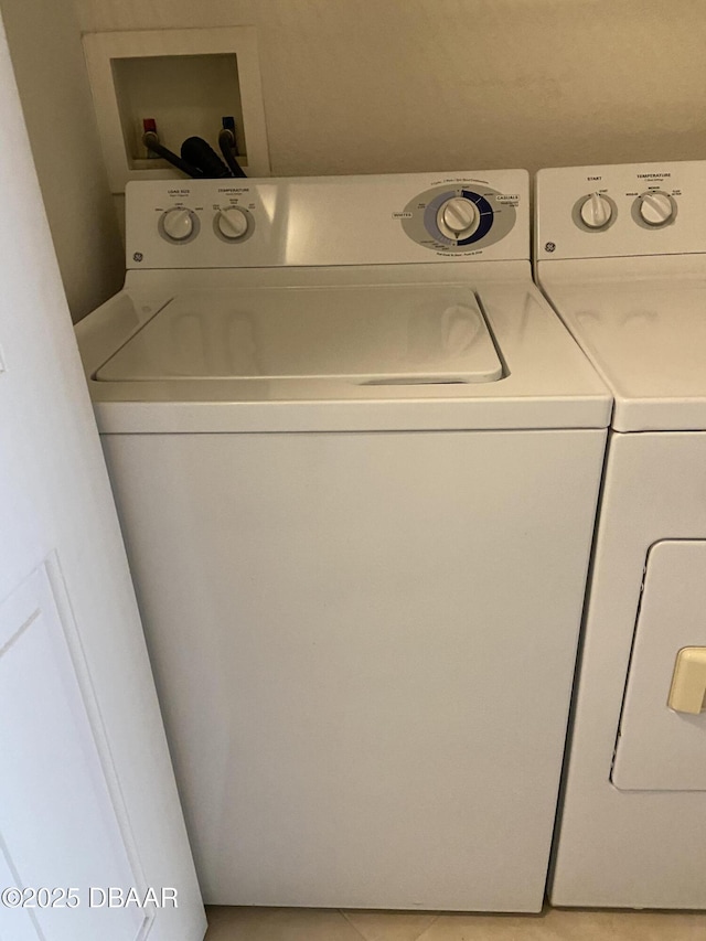 940 Village Trl Unit 2-106, Port Orange, FL 32127 - laundry area featuring separate washer and dryer and light tile patterned floors