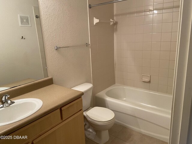 940 Village Trl Unit 2-106, Port Orange, FL 32127 - full bathroom featuring tile patterned flooring, toilet, vanity, a textured wall, and shower / bath combination