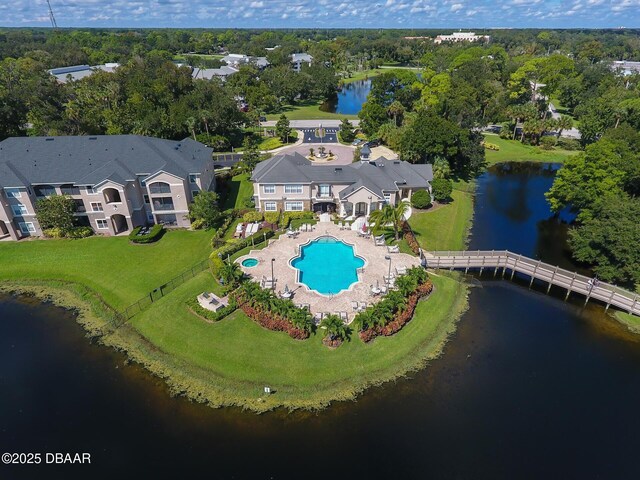 940 Village Trl Unit 2-106, Port Orange, FL 32127 - bird's eye view of a pool, a nearby body of water, and a tree filled landscape