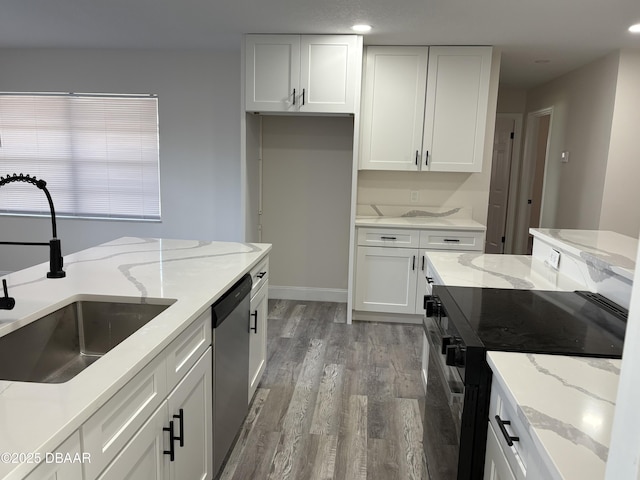 304 Jane Ann St, Port Orange, FL 32127 - kitchen with black range, stainless steel dishwasher, light wood-type flooring, white cabinetry, and recessed lighting