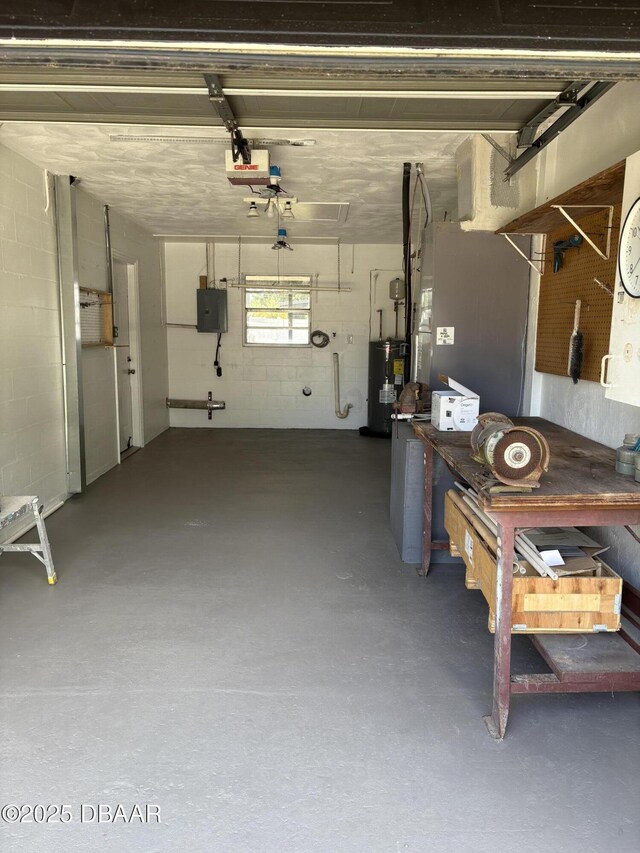 304 Jane Ann St, Port Orange, FL 32127 - garage with electric water heater, electric panel, a workshop area, a garage door opener, and concrete block wall