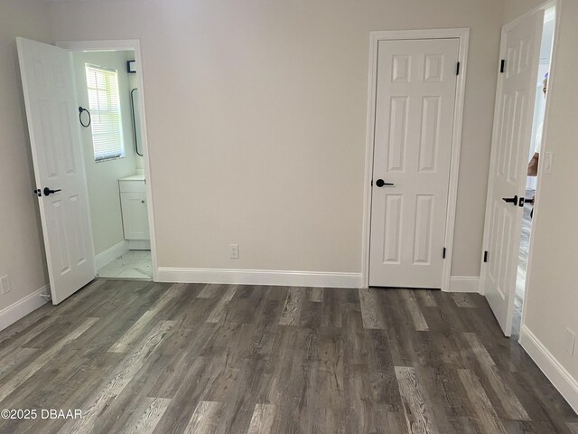 304 Jane Ann St, Port Orange, FL 32127 - unfurnished bedroom featuring wood finished floors and connected bathroom