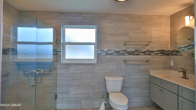 bathroom featuring vanity, toilet, and a shower with door