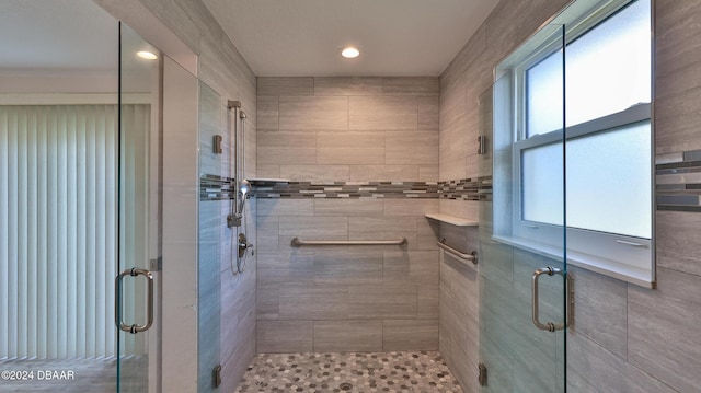 bathroom featuring a shower with shower door