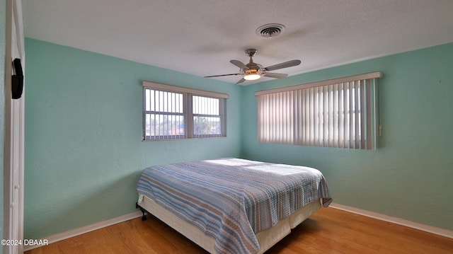 bedroom with ceiling fan and light hardwood / wood-style floors