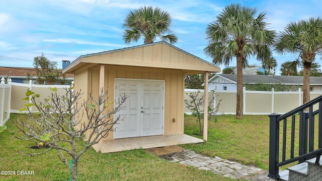 view of outbuilding with a yard