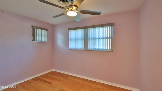 unfurnished room featuring light wood-type flooring and ceiling fan