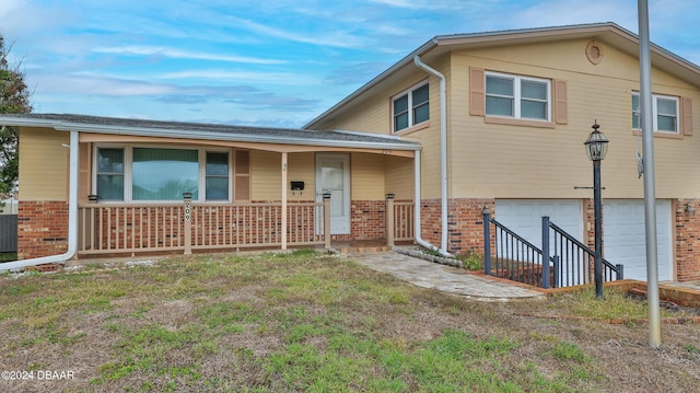 view of front of house featuring covered porch and a garage