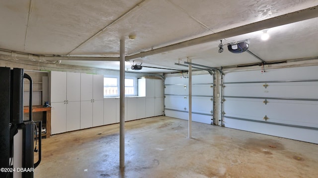 garage with black fridge and a garage door opener