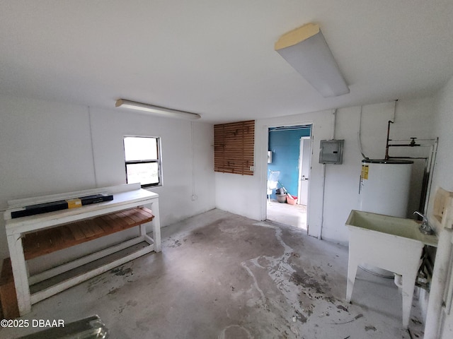 interior space featuring water heater, electric panel, and sink