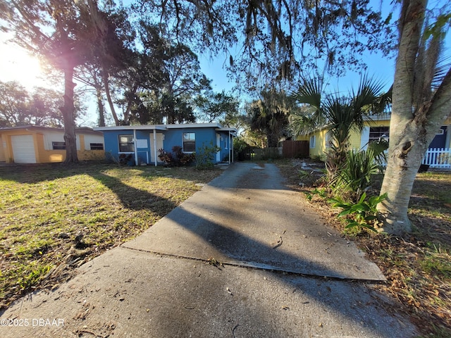 single story home with a front lawn and a garage