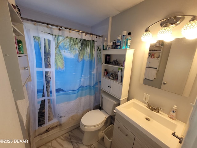 bathroom featuring curtained shower, vanity, and toilet