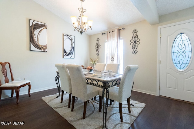 dining area with dark hardwood / wood-style flooring, an inviting chandelier, and a textured ceiling