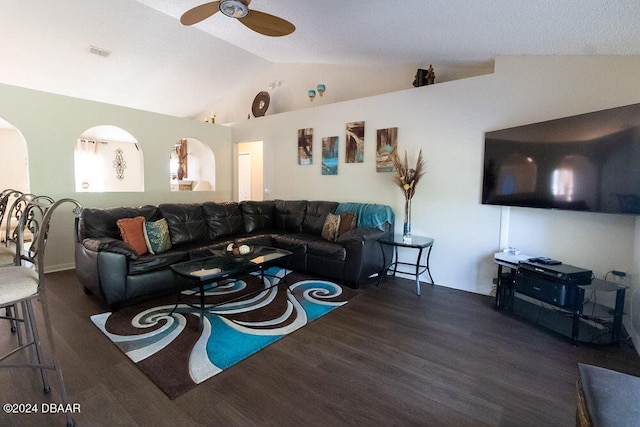 living room with dark wood-type flooring, ceiling fan, and vaulted ceiling