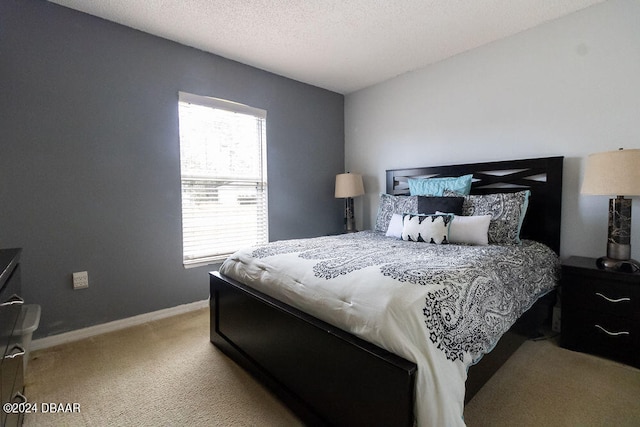 carpeted bedroom featuring a textured ceiling