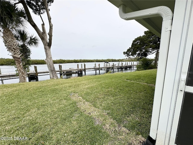 84 Heather Point Ct, New Smyrna Beach, FL 32169 - dock area with a water view and a lawn