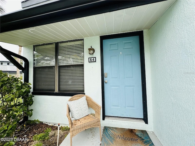 84 Heather Point Ct, New Smyrna Beach, FL 32169 - view of exterior entry featuring stucco siding and covered porch