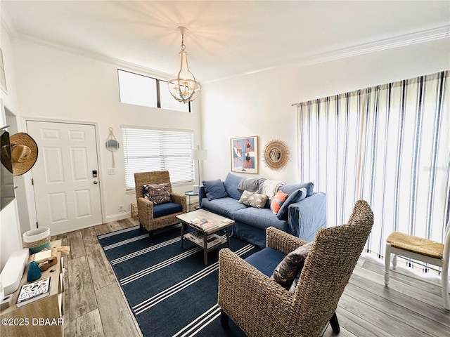 84 Heather Point Ct, New Smyrna Beach, FL 32169 - living area featuring a chandelier, crown molding, and wood finished floors