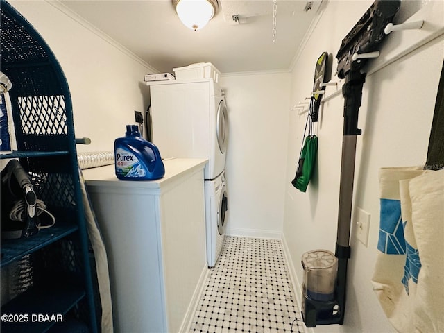 84 Heather Point Ct, New Smyrna Beach, FL 32169 - laundry area featuring stacked washing machine and dryer, crown molding, baseboards, and light floors