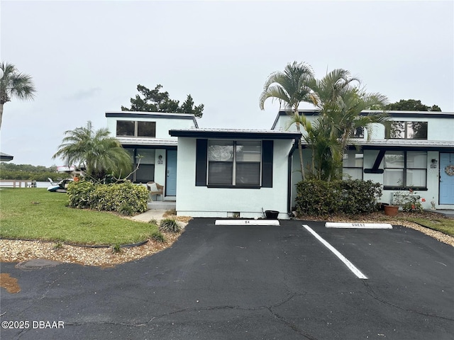 84 Heather Point Ct, New Smyrna Beach, FL 32169 - view of front of home with uncovered parking, a front yard, and a porch