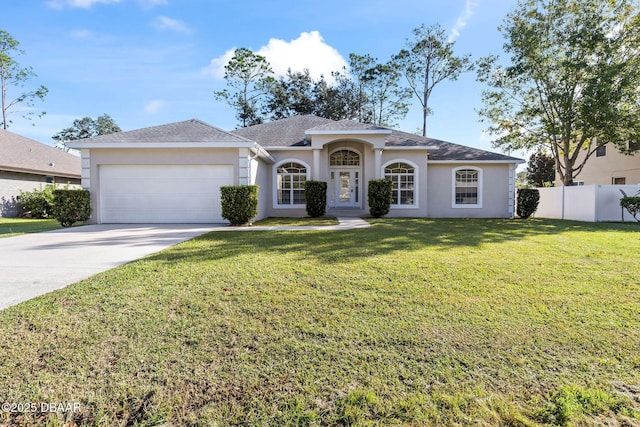 single story home with a garage and a front lawn