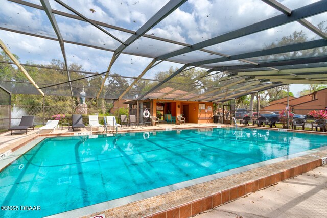 community pool with a patio area and a lanai