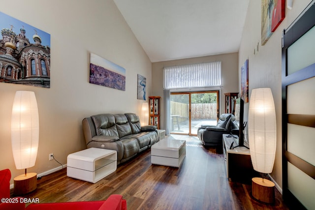 living area with wood finished floors, high vaulted ceiling, and baseboards