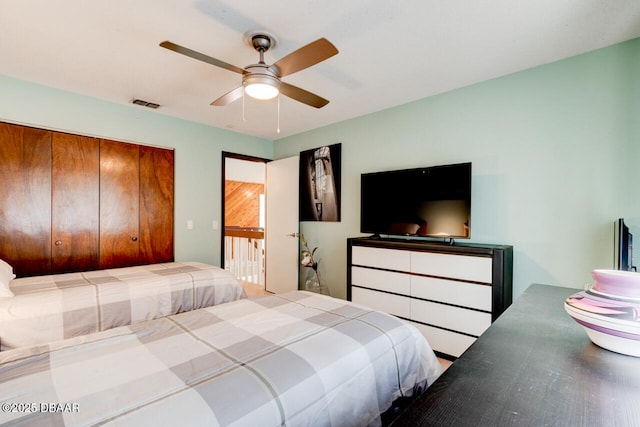 bedroom featuring ceiling fan and a closet