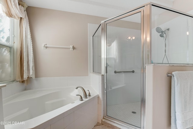 bathroom featuring a shower stall and a garden tub