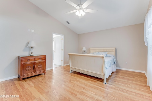 bedroom featuring visible vents, lofted ceiling, wood finished floors, baseboards, and ceiling fan