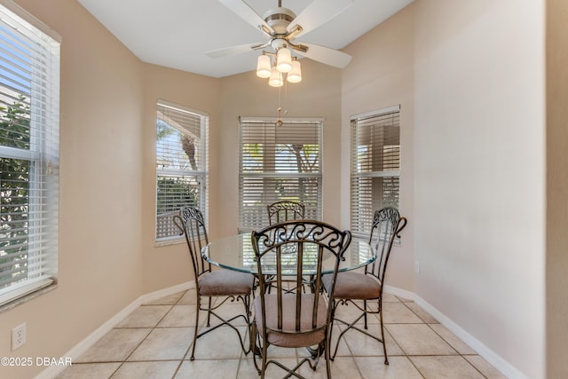 dining room featuring light tile patterned floors, a ceiling fan, and baseboards