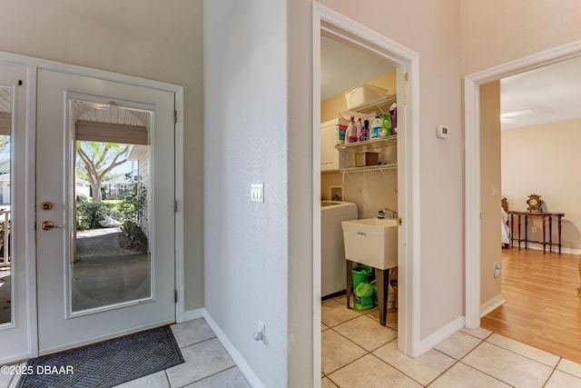 entryway with light tile patterned floors and baseboards